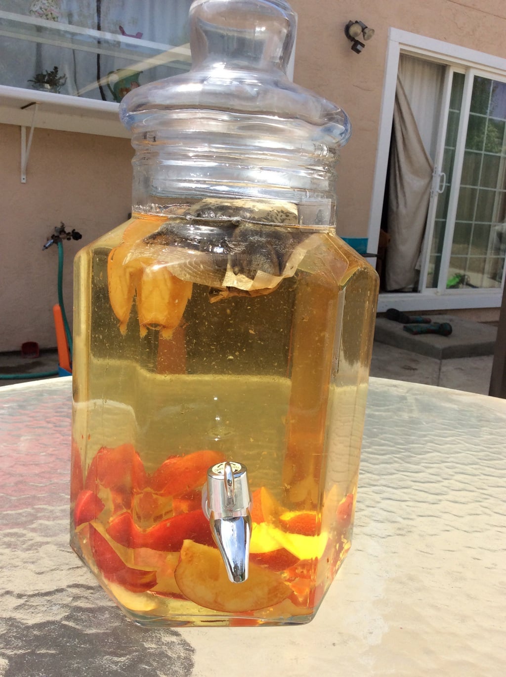 Water and tea bags in a container, ready to be made into sun tea.