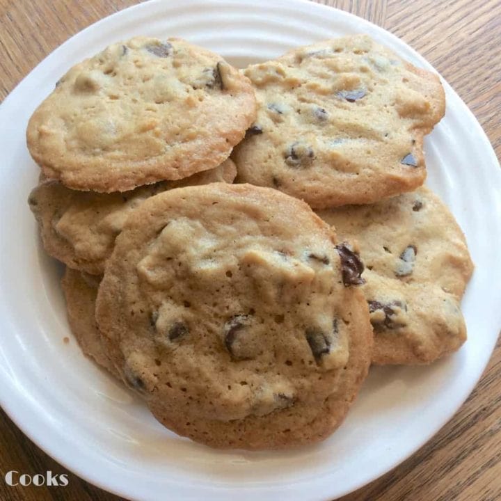 A white plate piled with soft peanut butter chocolate chunk cookies.