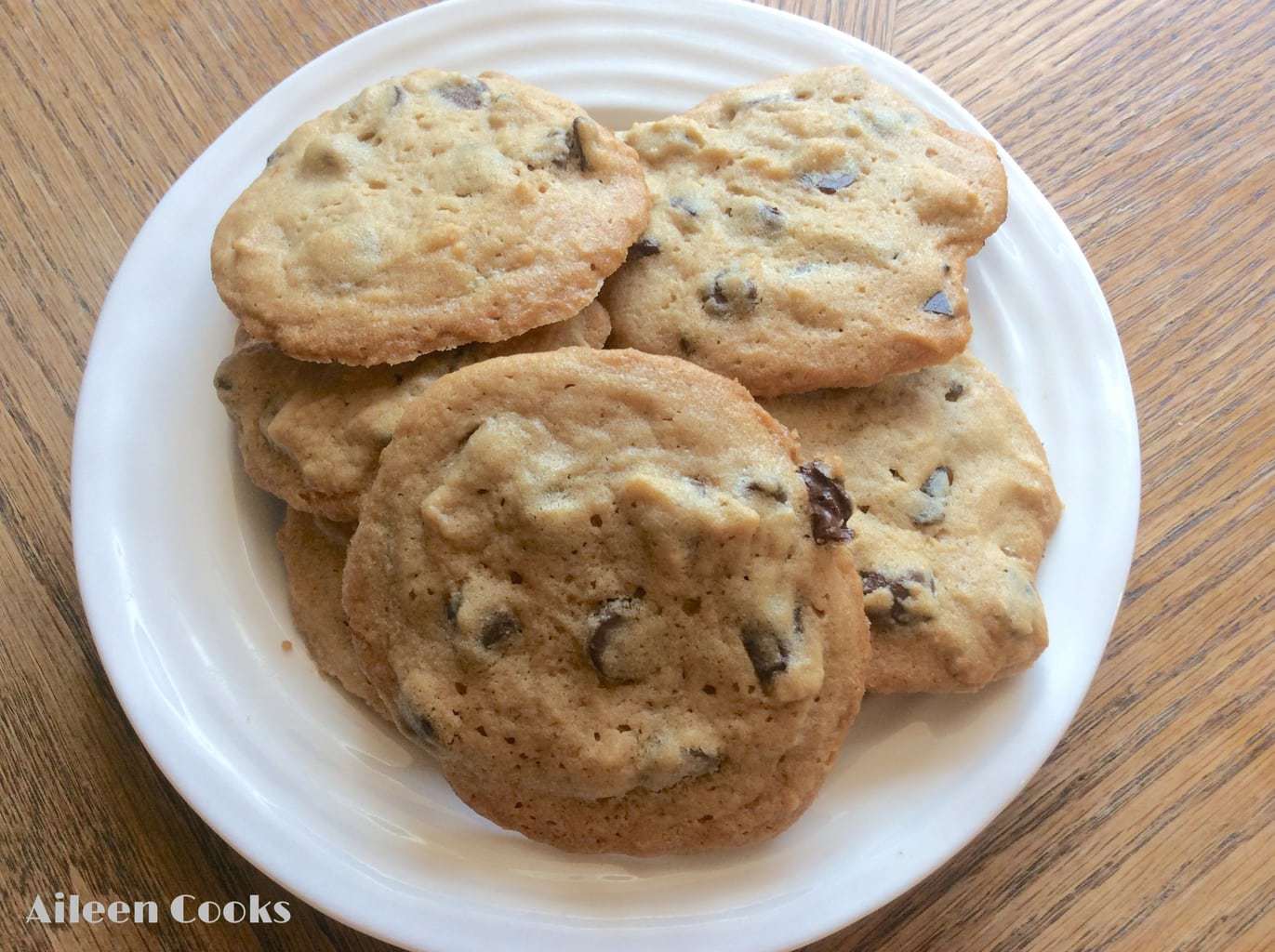 A white plate piled with soft peanut butter chocolate chunk cookies.
