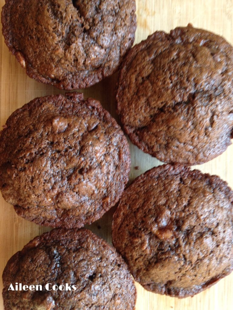 Overhead shot of 5 double chocolate muffins in two rows.