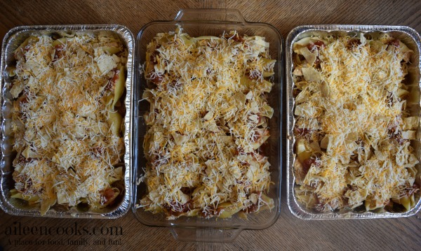 Three prepared casseroles ready to be frozen.