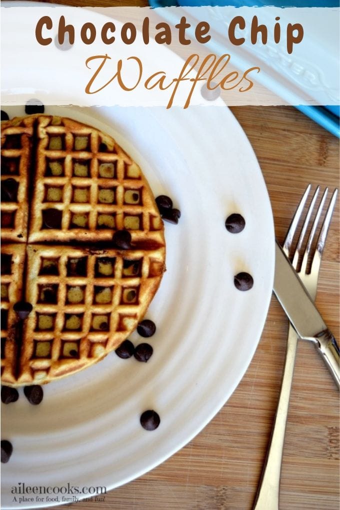 A white plate with chocolate chips waffle recipe next to a fork and knife.