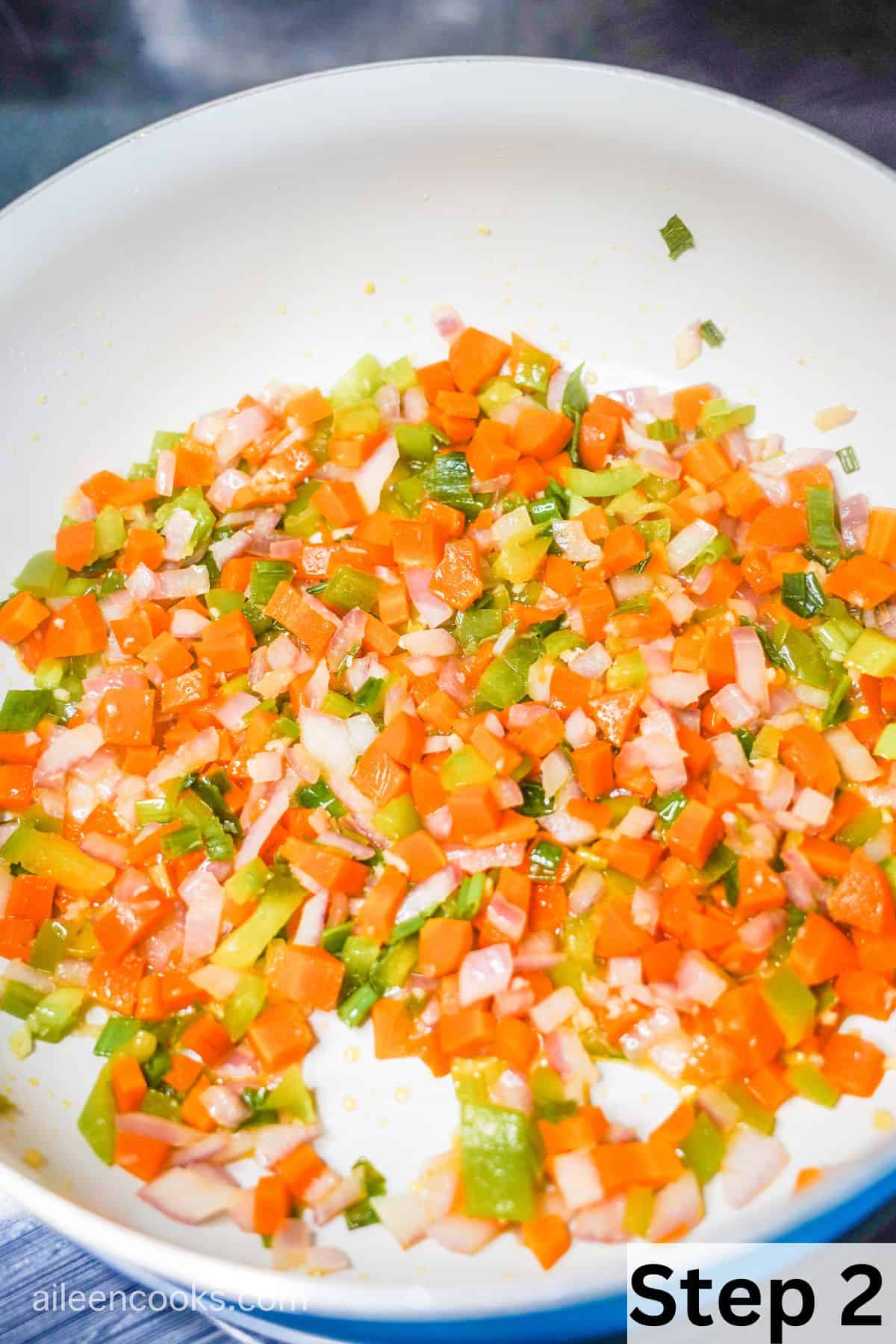 Cooked carrots, onions, and garlic in a large skillet.