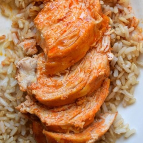 Easy and healthy crockpot buffalo chicken with just 4 ingredients make this slow cooker chicken dinner the perfect weeknight meal. Recipe from aileencooks.com
