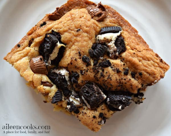 Peanut Butter Cup Cookie Bars are filled with mini Reese's, Oreos, and semi-sweet chocolate chips. They are so much better than the regular blondies recipe! Recipe from aileencooks.com