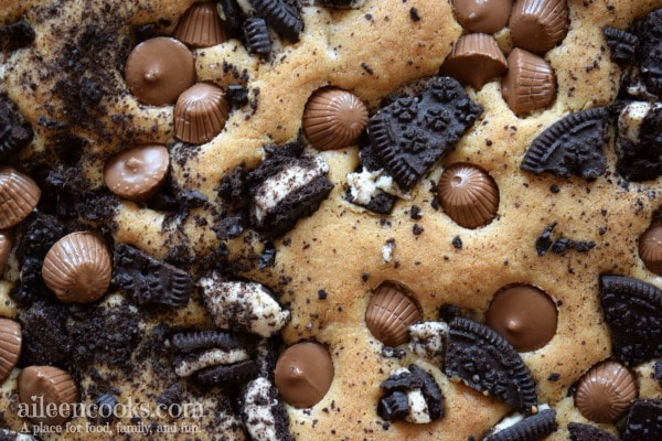 Peanut Butter Cup Cookie Bars are filled with mini Reese's, Oreos, and semi-sweet chocolate chips. They are so much better than the regular blondies recipe! Recipe from aileencooks.com