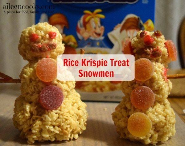 Fun and festive rice krispie treat snowmen made with rice krispies, cocoa krispies, and holiday rice krispies. Such a fun christmas tradition! Cooking With Kids Recipe from aileencooks.com #TidingsAndTreats #ad