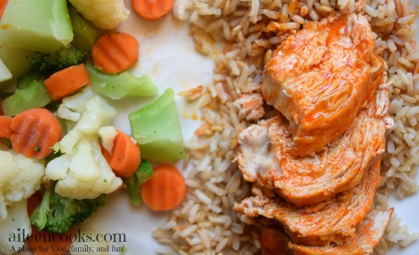 Easy and healthy crockpot buffalo chicken with just 4 ingredients make this slow cooker chicken dinner the perfect weeknight meal. Recipe from aileencooks.com