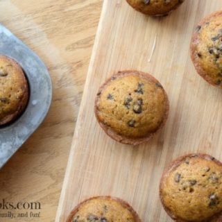 Quick and easy pumpkin chocolate chip muffins, perfect for breakfast, sports games, or pot lucks. This recipe takes 30 minutes and makes 3 dozen muffins! Recipe from aileencooks.com.