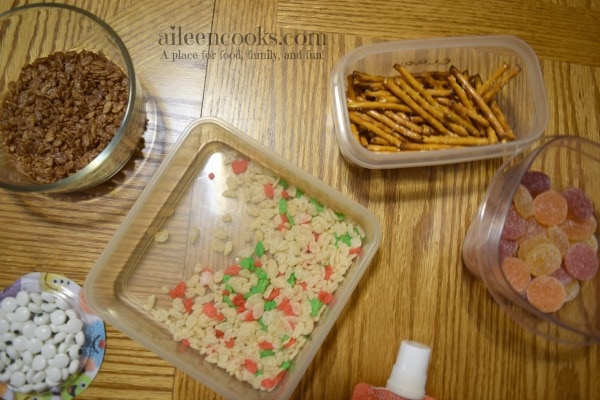 Fun and festive rice krispie treat snowmen made with rice krispies, cocoa krispies, and holiday rice krispies. Such a fun christmas tradition! Cooking With Kids Recipe from aileencooks.com #ad