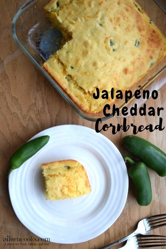 Glass baking dish of jalapeño cheddar cornbread above a white plate with a slice of cornbread.