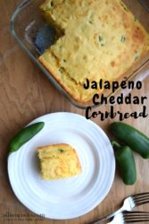 Glass baking dish of jalapeño cheddar cornbread above a white plate with a slice of cornbread.
