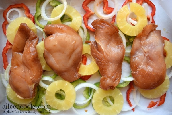 Baked Teriyaki Chicken with Pineapple, red and green peppers, and sweet onions. Served over a bed of brown rice. This easy weeknight meal is healthy and kid friendly. Recipe from aileencooks.com. #ad #stirupthefun @minutericeUS, @DoleSunshine, @kikkomanusa