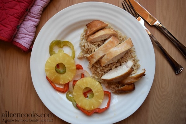 Baked Teriyaki Chicken with Pineapple, red and green peppers, and sweet onions. Served over a bed of brown rice. This easy weeknight meal is healthy and kid friendly. Recipe from aileencooks.com. #ad #stirupthefun @minutericeUS, @DoleSunshine, @kikkomanusa