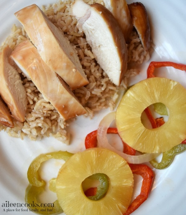 Baked Teriyaki Chicken with Pineapple, red and green peppers, and sweet onions. Served over a bed of brown rice. This easy weeknight meal is healthy and kid friendly. Recipe from aileencooks.com. #ad #stirupthefun @minutericeUS, @DoleSunshine, @kikkomanusa