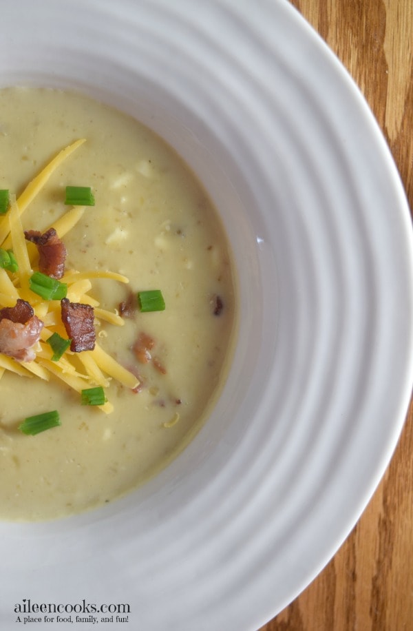 So good! Instant Pot Potato Soup loaded with yukon gold potatoes, bacon, half and half, 2 different kinds of cheeses, and topped with green onions. Easy to make in the instant pot electric pressure cooker. soup recipes. instant pot recipes. baked potato soup recipes. Recipe from aileencooks.com.