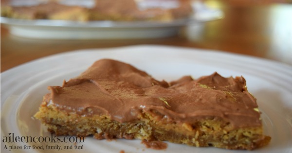 Peanut Butter Bars with Chocolate Frosting made with a chewy peanut butter cookie base, natural peanut butter, and creamy chocolate frosting. You even get to sneak some whole grains into your kid's diet with this recipe! Recipe for Peanut Butter Bars with Chocolate Frosting from aileencooks.com