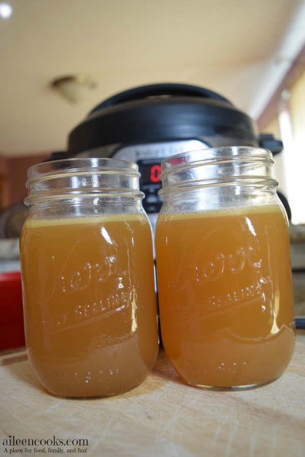 Make healthy and homemade chicken broth in under an hour with the instant pot! Recipe for Instant Pot Chicken Stock from aileencooks.com.