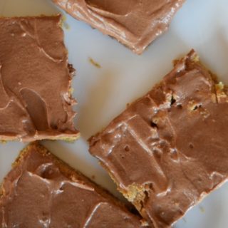 Peanut Butter Bars with Chocolate Frosting made with a chewy peanut butter cookie base, natural peanut butter, and creamy chocolate frosting. You even get to sneak some whole grains into your kid's diet with this recipe! Recipe for Peanut Butter Bars with Chocolate Frosting from aileencooks.com