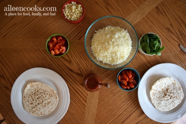 Cooking With Kids: Colorful Pita Pizzas. Get your kids in the kitchen with this fun and flavorful recipe for kids. Recipe from aileencooks.com.