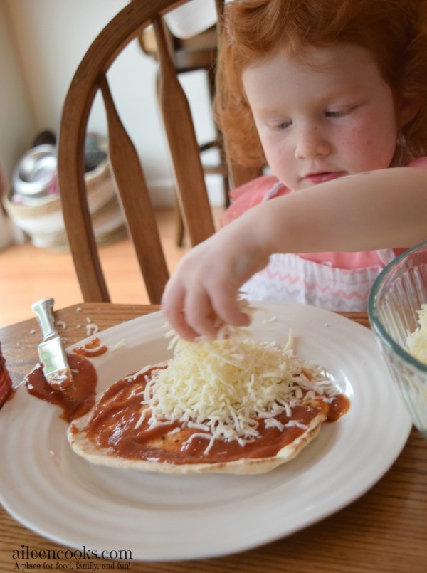 Cooking With Kids: Colorful Pita Pizzas. Get your kids in the kitchen with this fun and flavorful recipe for kids. Recipe from aileencooks.com.