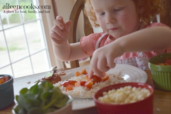 Cooking With Kids: Colorful Pita Pizzas. Get your kids in the kitchen with this fun and flavorful recipe for kids. Recipe from aileencooks.com.