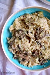 Blue bowl with instant pot mushrooom risotto inside on a white tablecloth