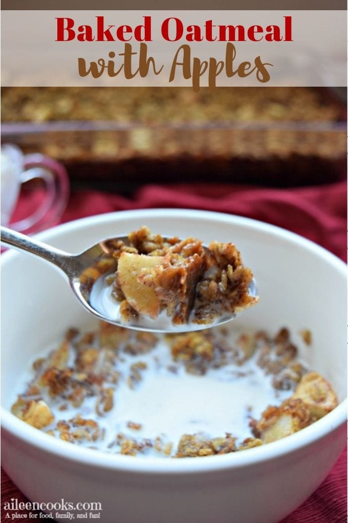 A bowl of baked oatmeal with apples with a bite on a spoon.