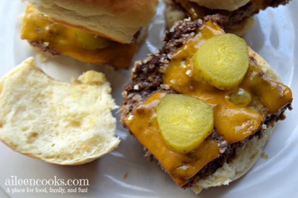 Cheeseburger slider with the bun top next to it.