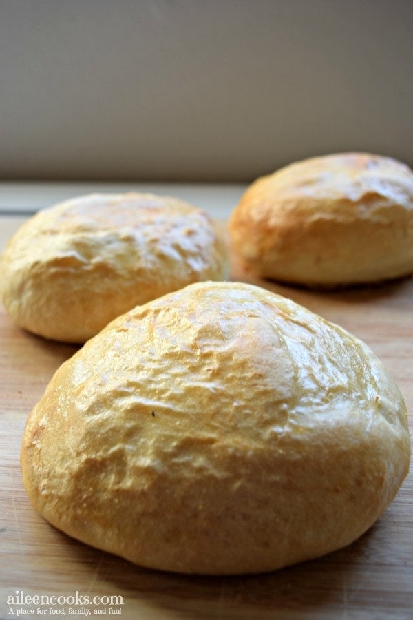 The completed Italian bread bowls recipe on a cutting board and ready to be served with soup or chili.