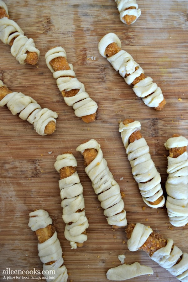 Halloween Mummy Chicken Fries. A fun twist on mummy dogs using crescent rolls and chicken fries.