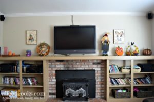 How we decorated our mantel for fall - scarecrows, pumpkins, and day of the dead.