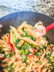 A ladle-full of smoked sausage and kale pasta.