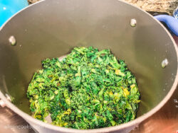 Cooked kale inside a large pot.