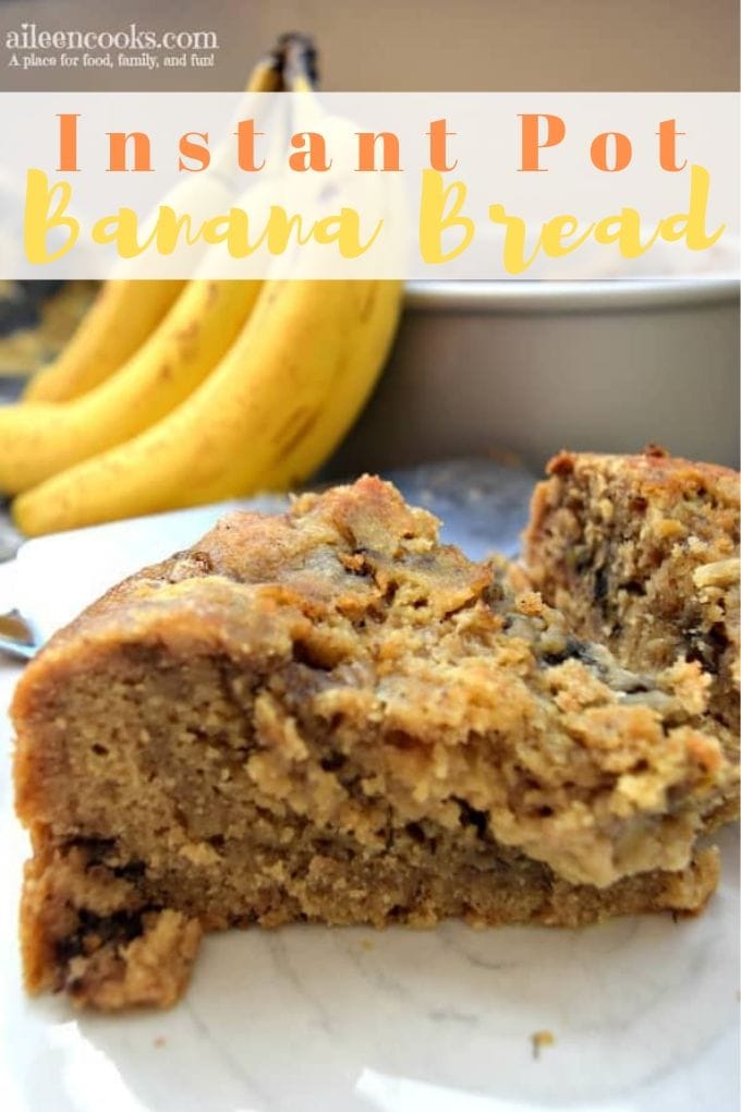 Two slices of instant pot banana bread on white plate with bananas in the background.