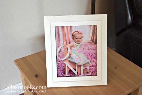 White picture frame with picture of little girl.