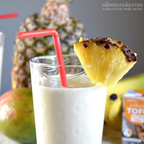 Smoothie in a glass with pineapple slice.