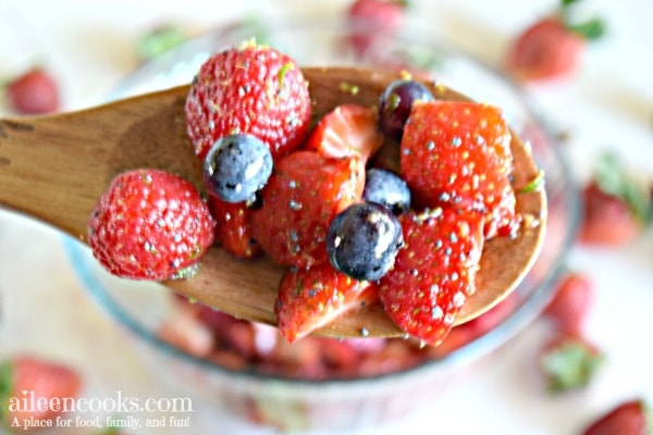 wooden spoon holding fruit salad