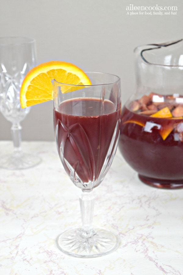 glass of red wine sangria with orange slice.