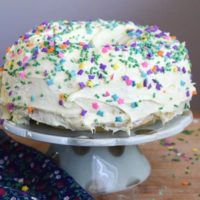 instant pot cake decorated with frosting and funfetti sprinkles.