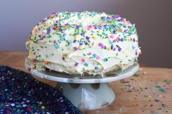 instant pot cake decorated with frosting and funfetti sprinkles.