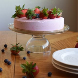 no-bake strawberry cheesecake on glass cake stand