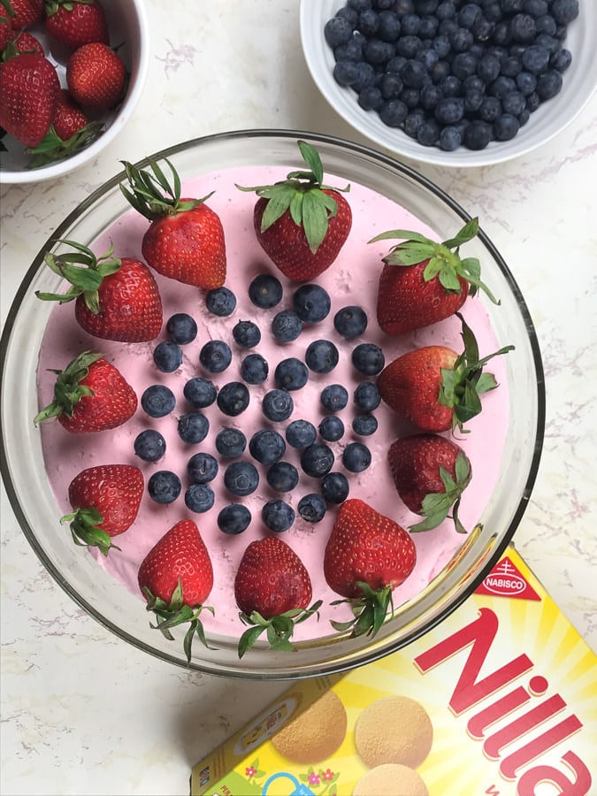 no-bake cheesecake with strawberries and blueberries on top.