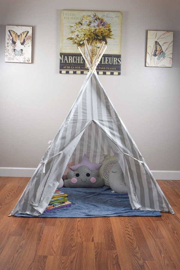 Reading nook teepee sitting inside a house with a white wall.