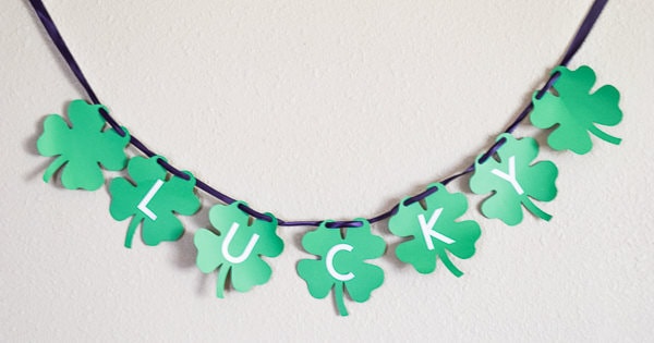 St. Patrick's Day Banner of green clovers with white letters on top spelling out "lucky" made with the cricut maker.
