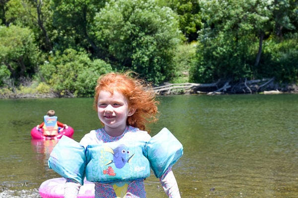 Young girl standing in front of the Russian River in Norther California.