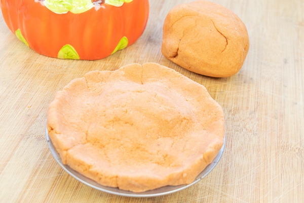 Pumpkin playdough in a mini pie plate.
