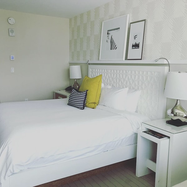 The bed at the Wyndham Grand Clearwater Beach had white linnens with grey and yellow throw pillows.