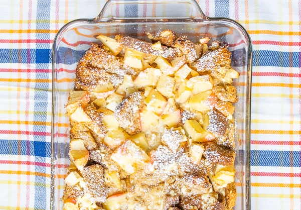 Apple-cinnamon french toast bake over a plaid tablecloth.