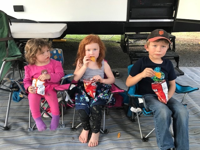 Three kids enjoying a snack at the Petaluma KOA.